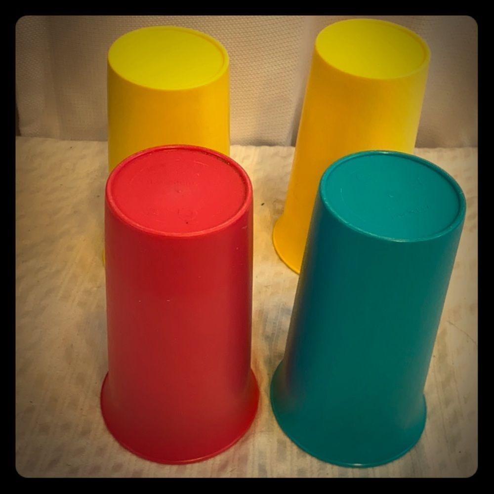 4 colored Tupperware tumblers. Measures 4 3/4”‎
